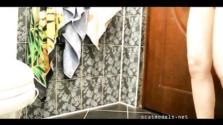 Amateur girl takes out hard nuggets of poop