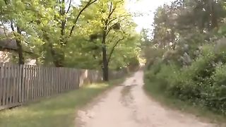 Sexy brunette chick pooping by an outhouse in the woods