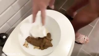 Tattooed blonde chick pooping in the toilet