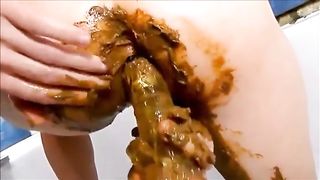 Girl shitting and masturbating with shitty dildo in solo