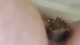 Horny looking MILF poops thick load