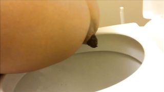 Young brunette in black teasing and pooping
