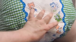 Girl pooping in a baby's diaper