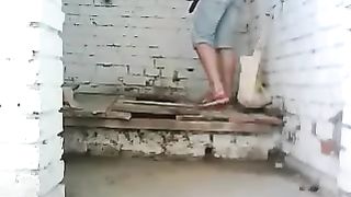Girl poops in a wooden toilet outdoor