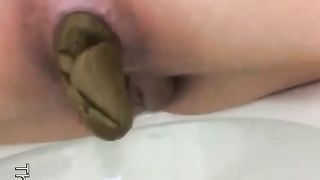 Hot blonde babe pooping closeup