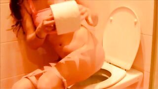 Cute lovely lady pooping in the toilet