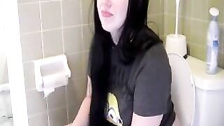 Cute brunette young babe pooping in the toilet