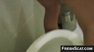 Chick dropping load in toilet closeup