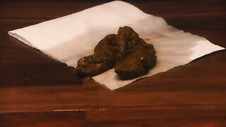 Redhead chick squats and drops a big shit on a napkin