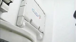 Young lady shitting on the toilet