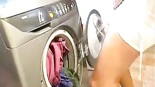 Girl peeing in the washing Machine