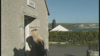 Girl pissing in the toilet s floor