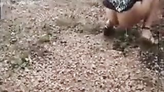 Girl peeing on the side of the road