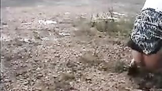 Girl peeing on the side of the road