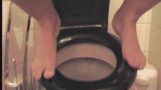 Girl squats atop of the toilet bowl to piss and poop