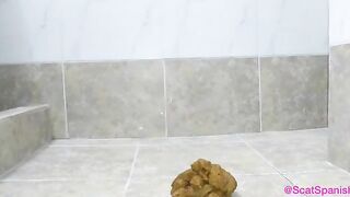 Pooping girl rubbing feet on her shit