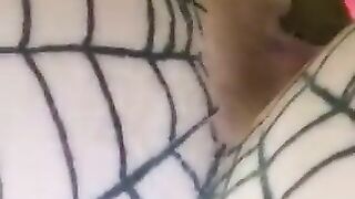 A woman's ass in a fishnet stocking and thong.