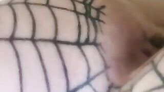 A woman's ass in a fishnet stocking and thong.