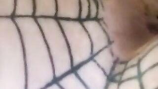 A woman's ass in a fishnet stocking and thong.