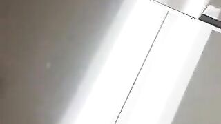 Woman covered in fishnet stockings squats on a pile of shit