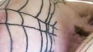 Woman covered in fishnet stockings squats on a pile of shit
