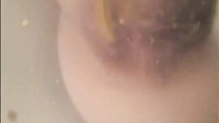 Woman shitting chunks in the water of bathtub