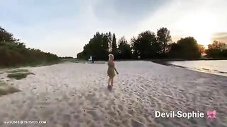 Pretty blonde babe poops in the sand