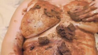 Mature lady smearing shit on her tits and pussy