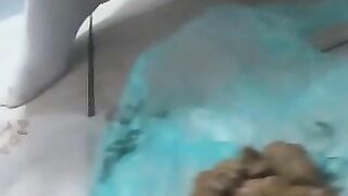 A blonde babe sits on the toilet and takes a massive shit