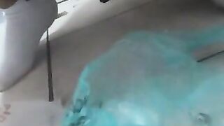 A blonde babe sits on the toilet and takes a massive shit