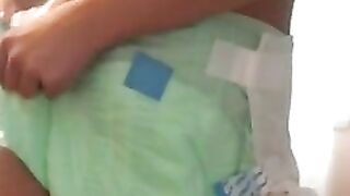 Skinny girl teasing in diaper