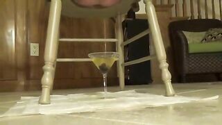 Busty babe shitting down from wooden chair