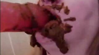 Dirty girl sucking and licking a huge shitty dildo