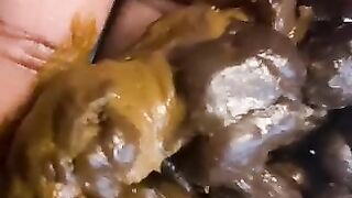 Ebony lady pushing pebbles