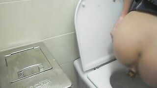 Elena takes a shit in a public toilet