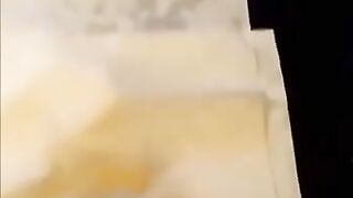 Woman squats over a pile of fresh shit on a mat