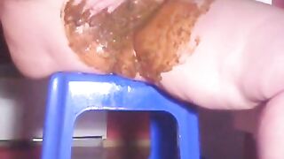 Brunette babe takes a big shit on blue stool