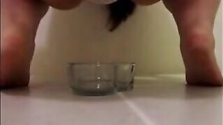 Mature woman pissing and shitting in the glass bowl