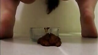 Mature woman pissing and shitting in the glass bowl