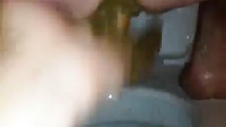 Slut in a bathtub licks her own shit