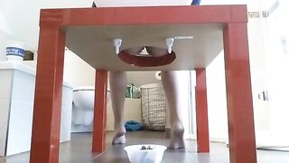 Woman takes a massive shit in a bowl under a table