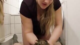 Blonde shits on another girl's belly in the bathroom