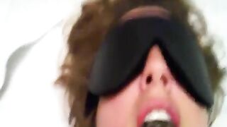 Woman in blindfold takes a massive brown turd in her mouth