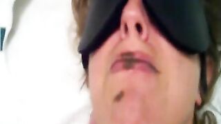 Woman in blindfold takes a massive brown turd in her mouth