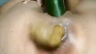 Girl pisses on a cucumber in her ass