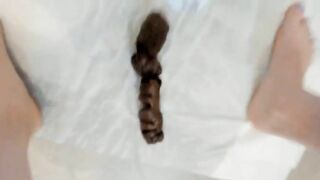 Woman takes a huge shit on white tiles