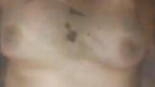 Woman spreads shit on her tits and stomach