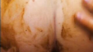Guy in tux squats while girl covers her in shit