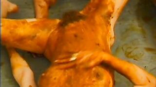 Two girls roll in a massive pile of shit