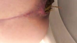 Woman sits on toilet to take a shit